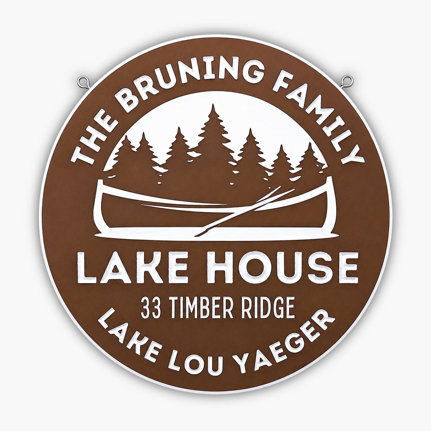 The Personalized Lake House, Cabin, or Retreat Sign is a round brown and white custom engraved sign reading: The Bruning Family Lake House, 33 Timber Ridge, Lake Lou Yaeger—with canoe and pine trees—ideal rustic decor for your lake house.