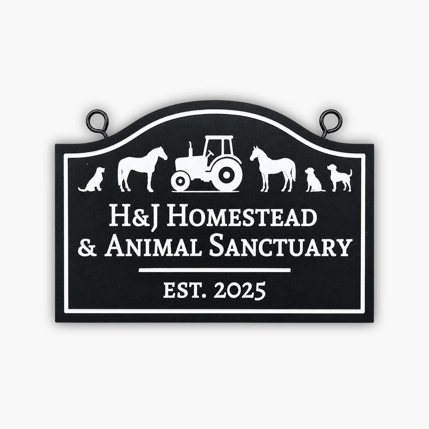 A black and white sign reads H&J Homestead & Animal Sanctuary EST. 2025 with silhouettes of a dog, horse, tractor, cat, goat, and another dog above the text.