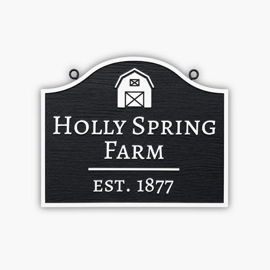 A Custom Carved Farm Sign & Ranch Sign – Engraved PVC Sign for Barns and Country Homes, in black and white with a barn icon, reads Holly Spring Farm Est. 1877.