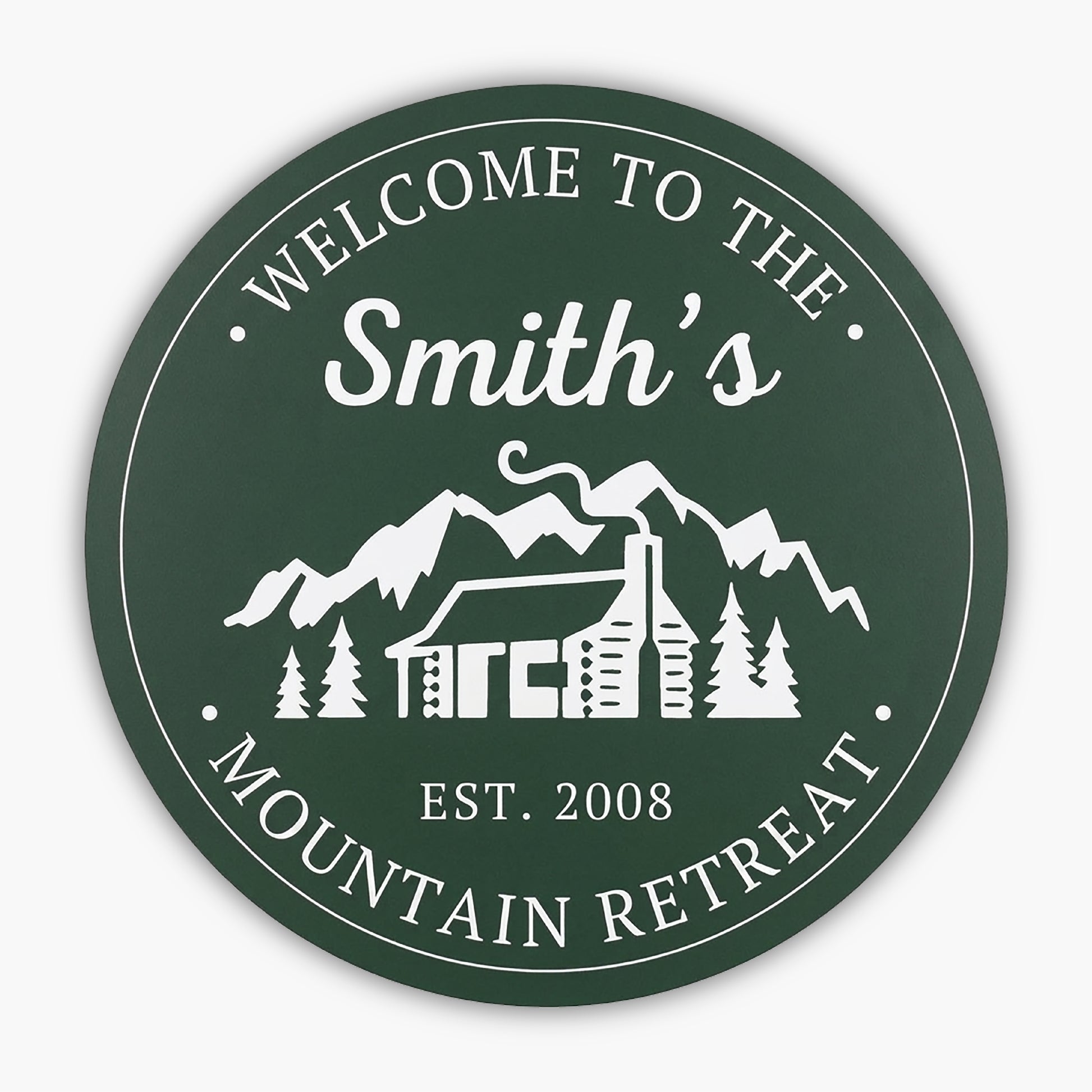 The Custom Carved Round PVC Cabin Sign welcomes guests with Welcome to the Smiths Mountain Retreat and Est. 2008, featuring a white illustration of a cabin, trees, and mountains, capturing the serene essence of this retreat beautifully.