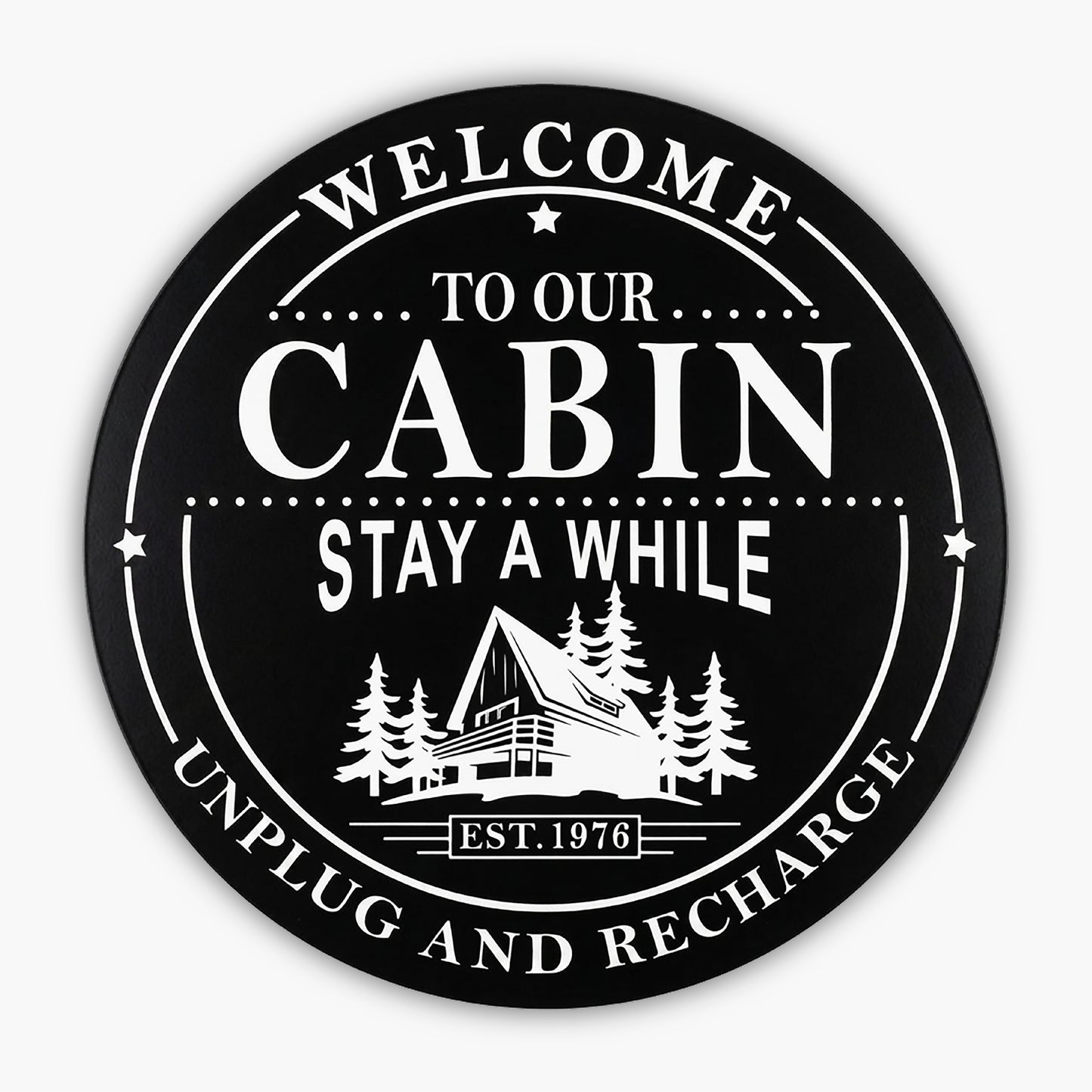 Custom Carved Round PVC Cabin Sign featuring a black circular design with Welcome to Our Cabin, Stay A While, Unplug and Recharge around an illustration of an A-frame cabin among trees. Established 1976 is displayed at the bottom.