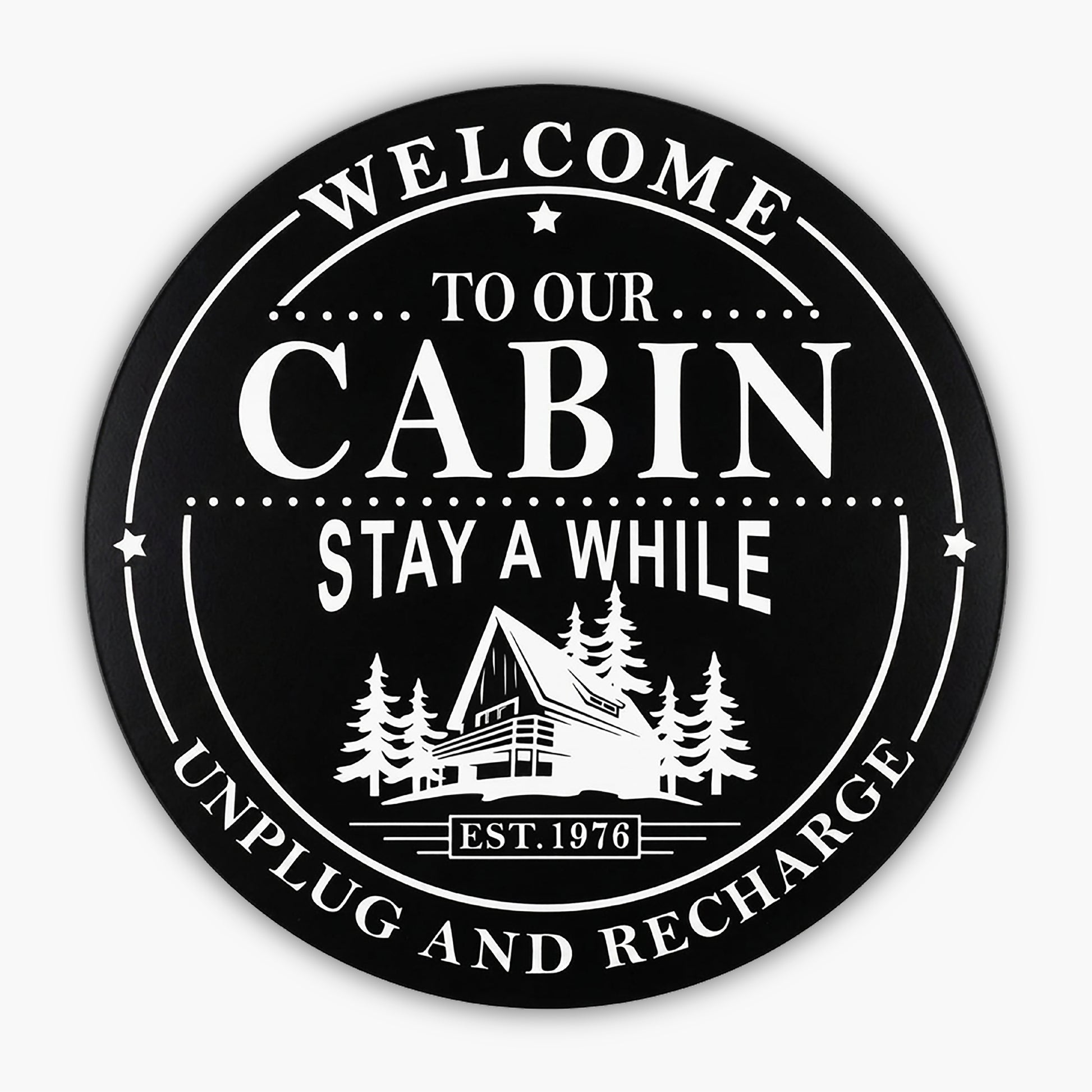 Custom Carved Round PVC Cabin Sign featuring a black circular design with Welcome to Our Cabin, Stay A While, Unplug and Recharge around an illustration of an A-frame cabin among trees. Established 1976 is displayed at the bottom.