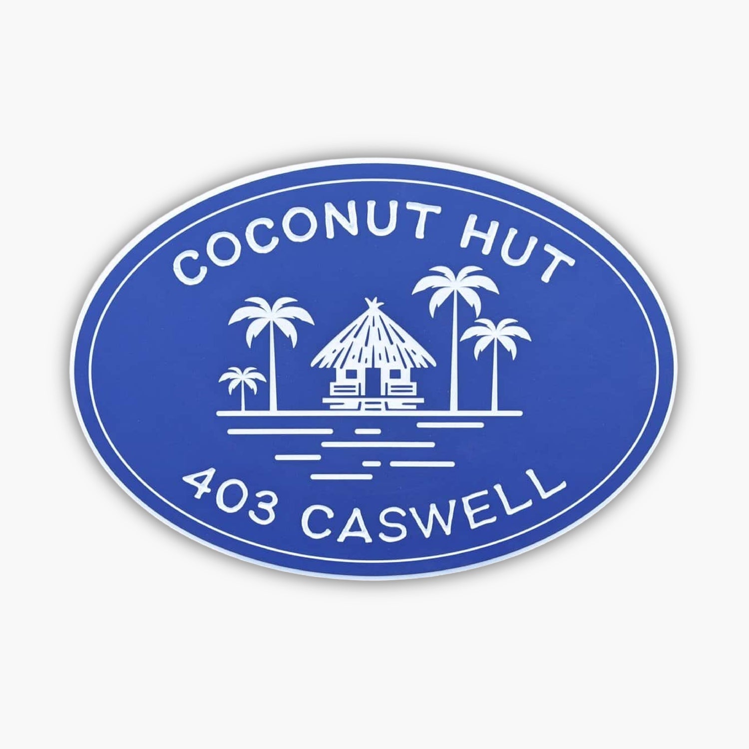 Custom carved pvc oval sign with white text that reads COCONUT HUT 403 CASWELL, featuring a drawing of a hut surrounded by palm trees and water.