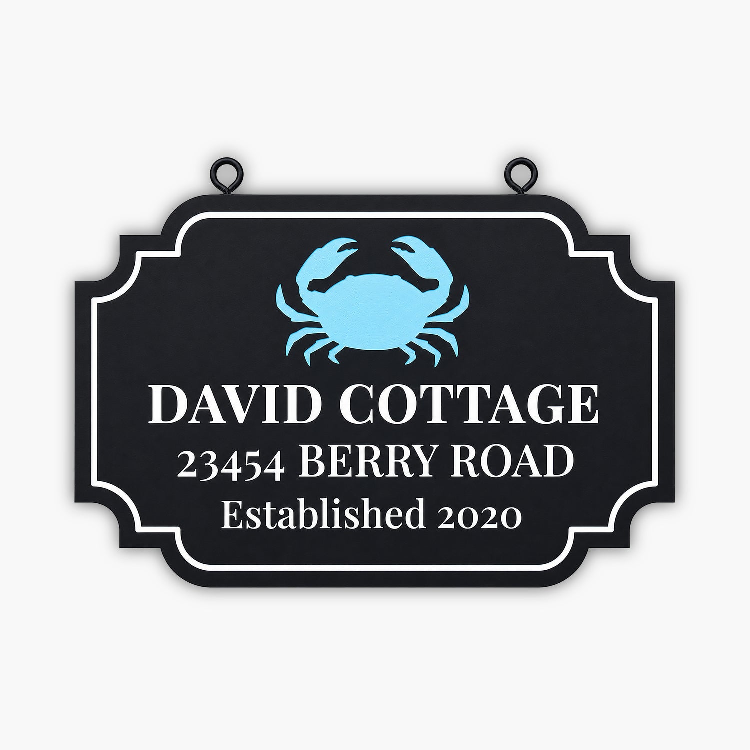 A black sign with a blue crab illustration reads: DAVID COTTAGE, 23454 BERRY ROAD, Established 2020 in white text. The sign has a decorative border.