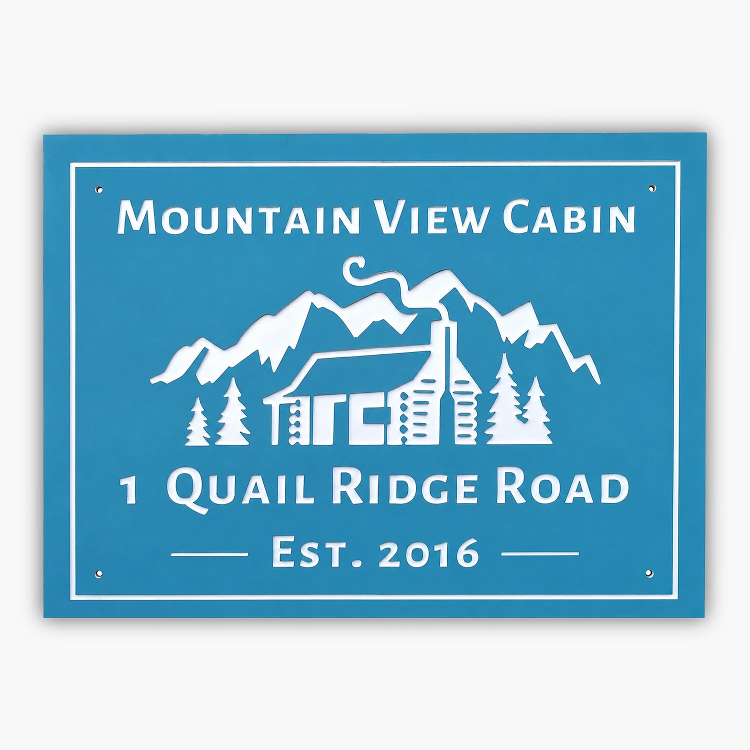 Blue sign with white text and graphics features Mountain View Cabin above a cabin with mountains and trees, reminiscent of an art gallery. Below, it reads 1 Quail Ridge Road and Est. 2016.