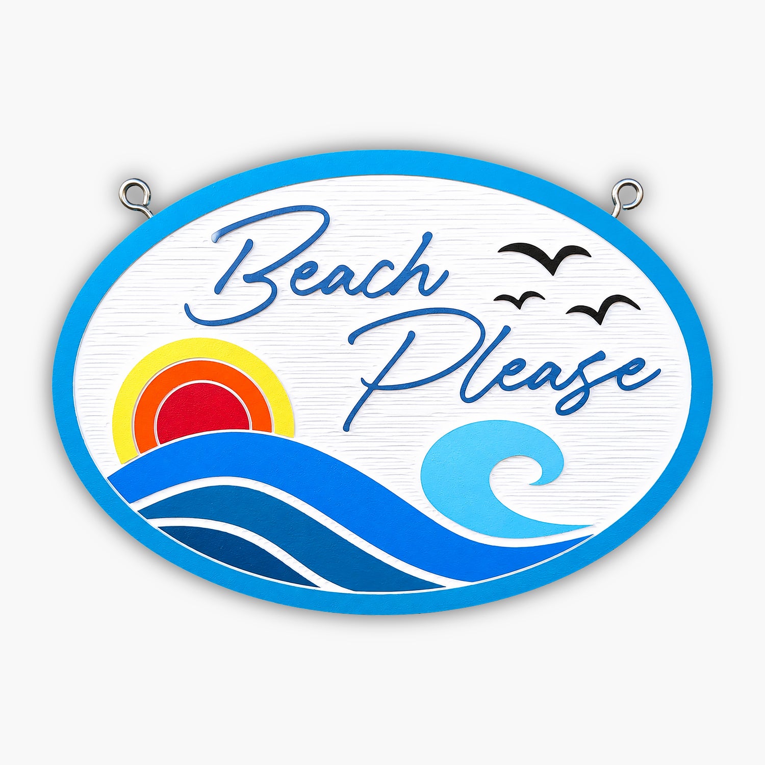 A decorative sign with the words Beach Please in script, featuring a stylized sun, waves, and two flying birds, all bordered by a blue oval frame. The background is light with a textured surface.