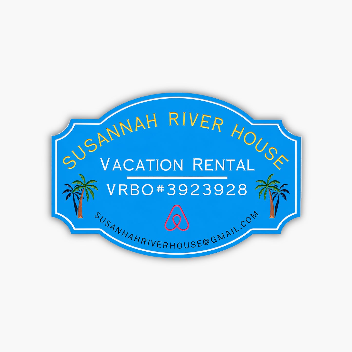 A custom home rental sign for Susannah River House features vibrant yellow and white text on a blue oval background with Vacation Rental VRBO#3923928, an Airbnb logo, palm tree illustrations, and the email address susannahriverhouse@gmail.com.