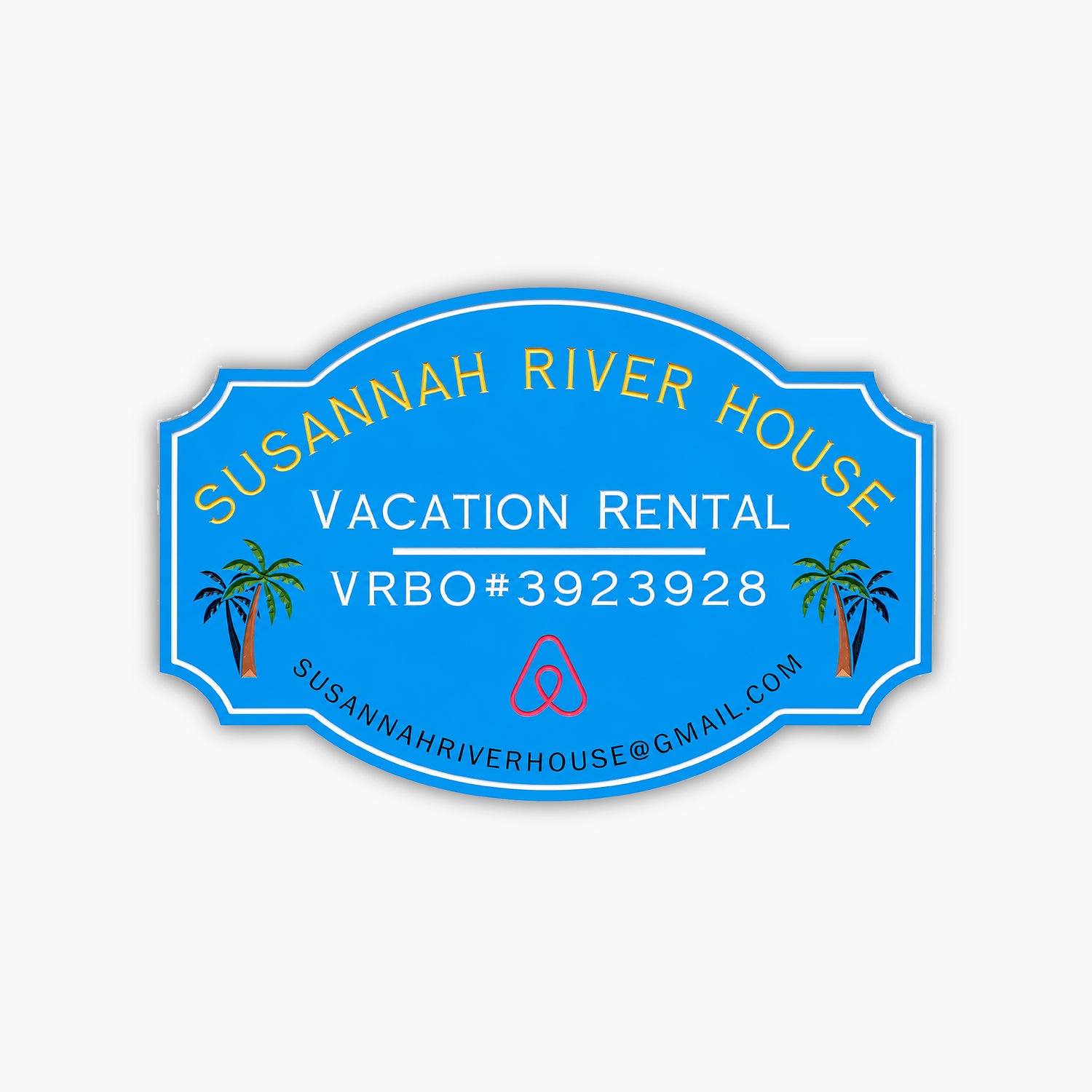 A custom home rental sign for Susannah River House features vibrant yellow and white text on a blue oval background with Vacation Rental VRBO#3923928, an Airbnb logo, palm tree illustrations, and the email address susannahriverhouse@gmail.com.