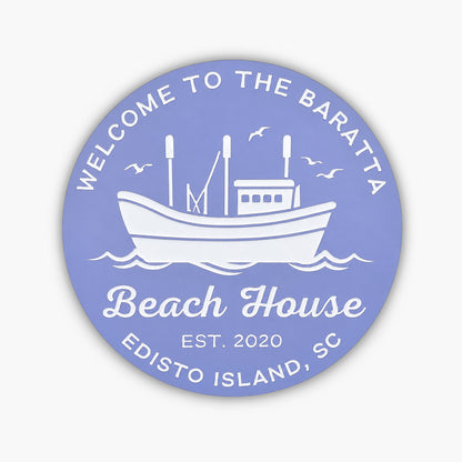 The Personalized Custom Round Beach House Sign Coastal Decor features a circular blue design with white text, reading: Welcome to the Baratta Beach House, Est. 2020, Edisto Island, SC, with a boat illustration and birds soaring above waves.