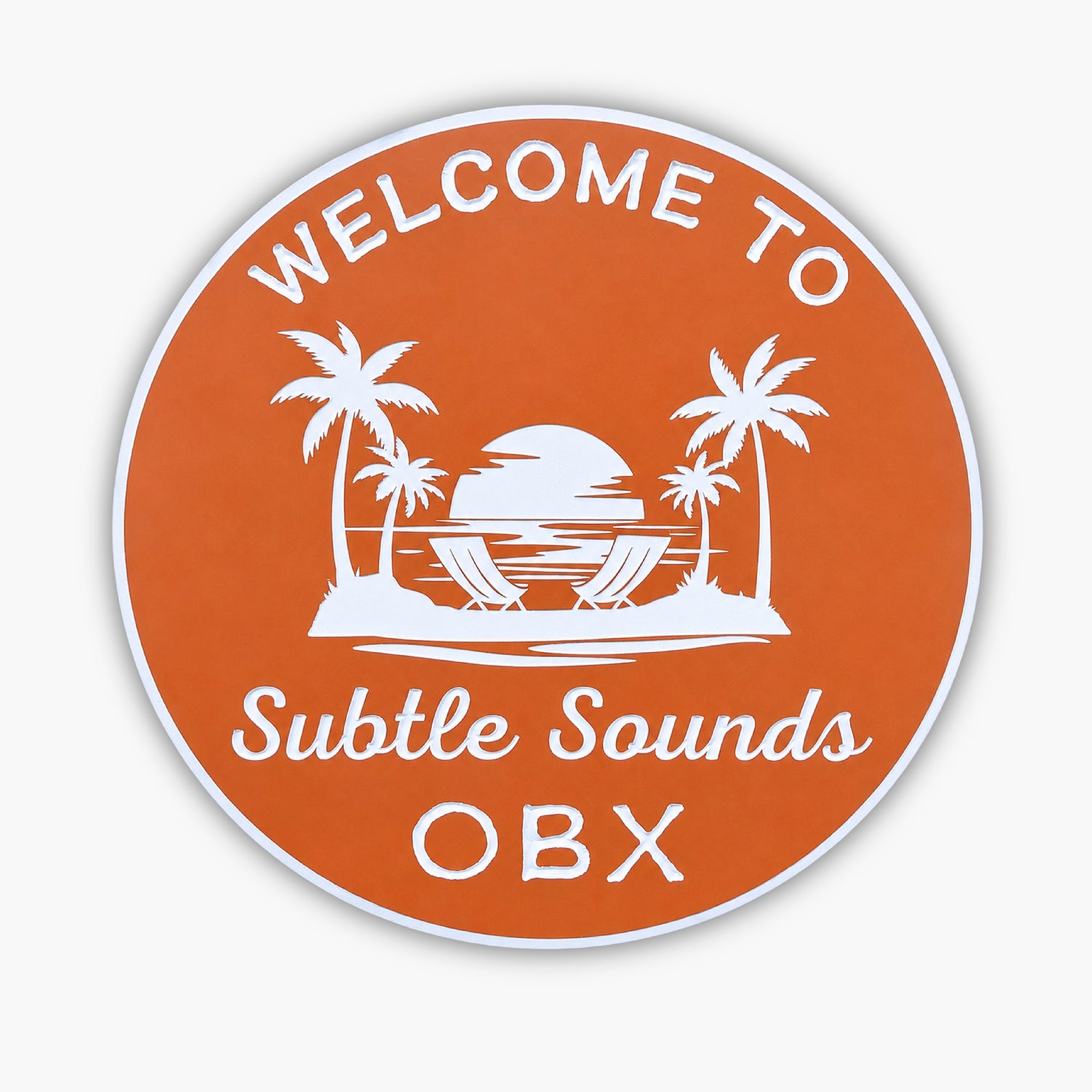 An orange round beach house sign featuring the text Welcome to Subtle Sounds OBX with palm trees and a setting sun over ocean waves. Product: Personalized Custom Round Beach House Sign Coastal Decor.