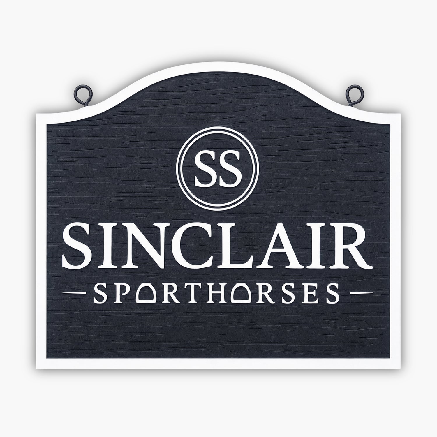 A black and white sign with the text SS Sinclair Sporthorses. The O in Sporthorses is stylized as a horseshoe. The sign has a wood texture.