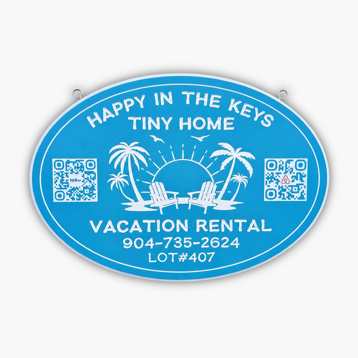Blue oval sign from Personalized Sign for Vacation Rental, Airbnb, VRBO; features white text: Happy in the Keys Tiny Home, Vacation Rental. Includes phone number, lot number, palm trees, chairs, sun, birds & two QR codes.