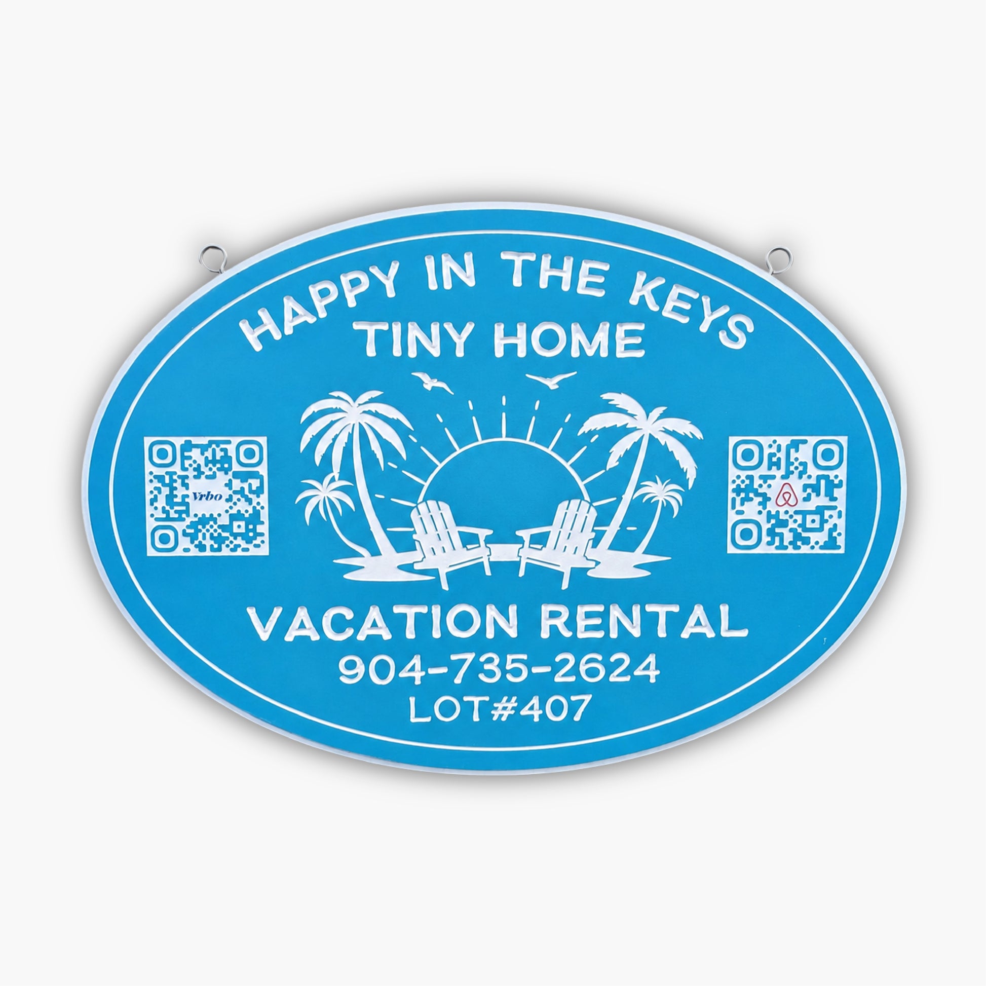 Blue oval sign from Personalized Sign for Vacation Rental, Airbnb, VRBO; features white text: Happy in the Keys Tiny Home, Vacation Rental. Includes phone number, lot number, palm trees, chairs, sun, birds & two QR codes.