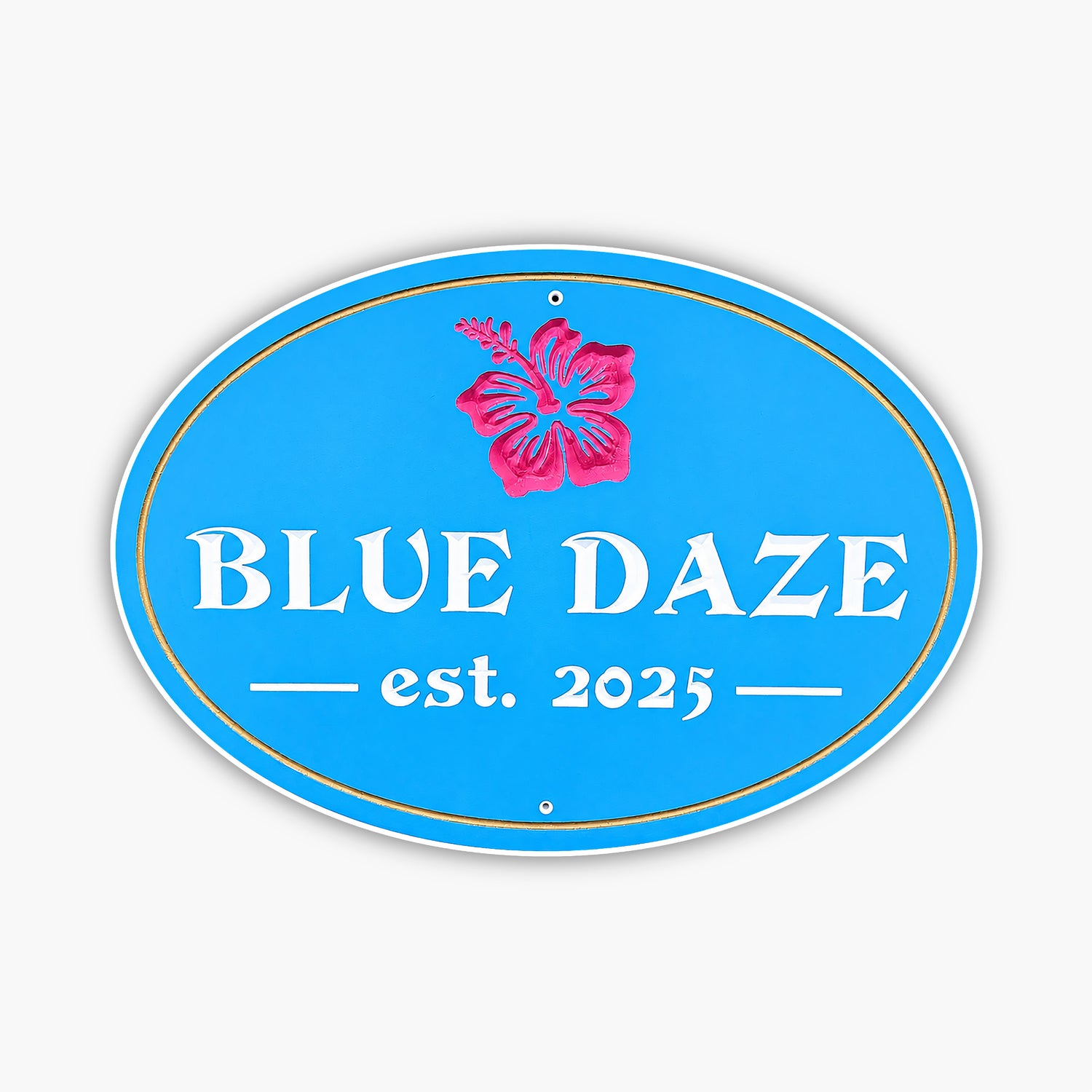 A blue oval gallery sign features a pink hibiscus flower at the top. It reads BLUE DAZE in white letters, with est. 2025 below, accented by decorative lines.