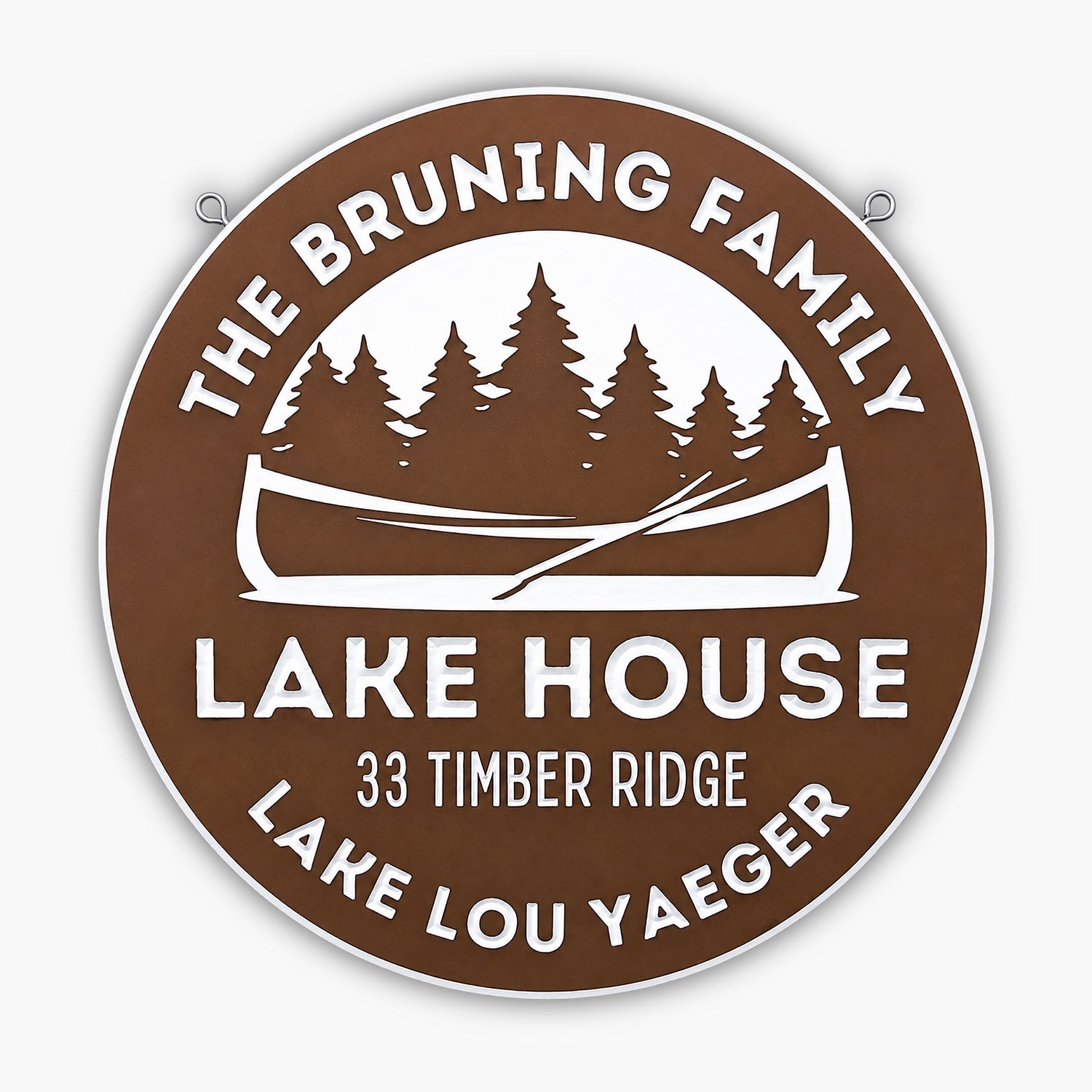 The Personalized Lake House, Cabin, or Retreat Sign is a round brown and white custom engraved sign reading: The Bruning Family Lake House, 33 Timber Ridge, Lake Lou Yaeger—with canoe and pine trees—ideal rustic decor for your lake house.